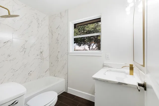 a bathroom with a sink a toilet and bathtub