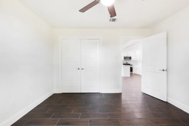a view of a room with wooden floor