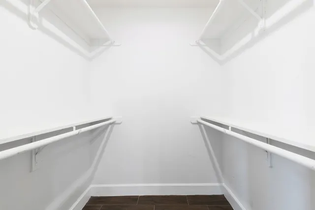 a view of closet with wooden floor