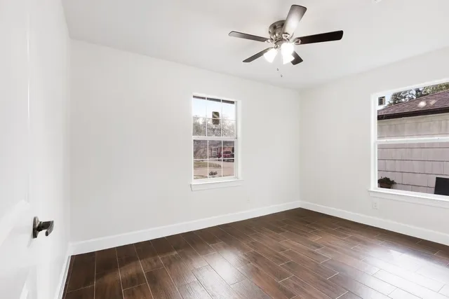wooden floor in an empty room with a window