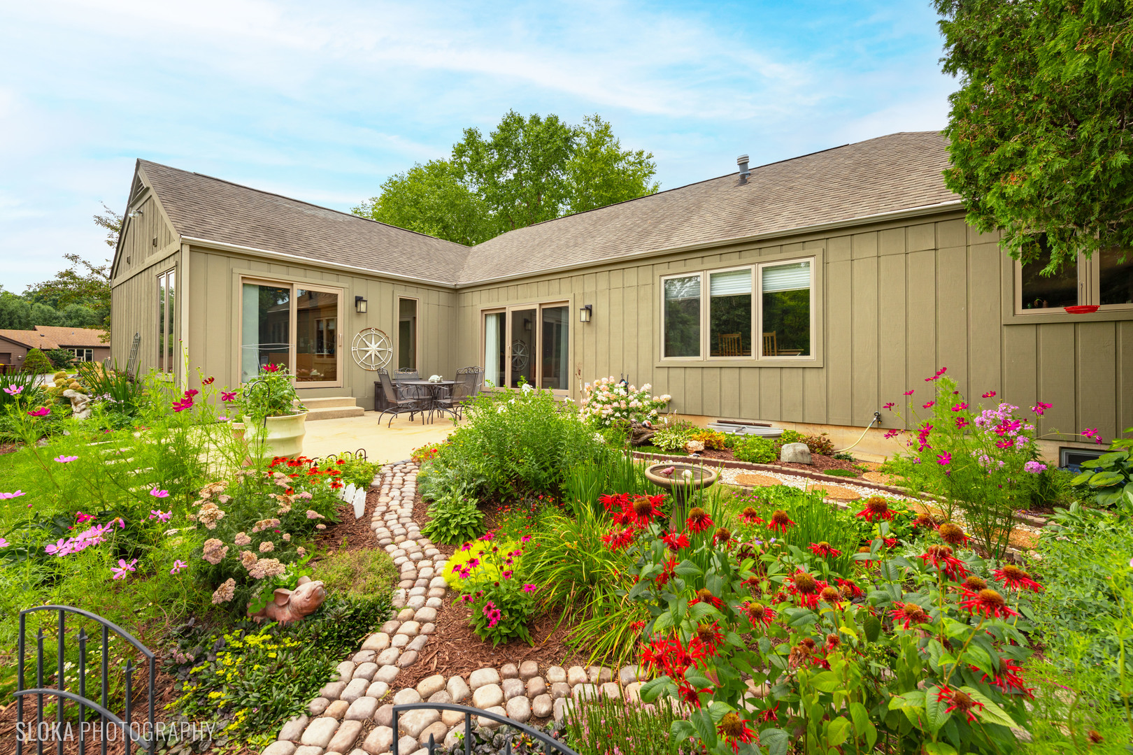 2920 Springbrook Road Crystal Lake, IL 60012 - Photo 30 of 39 a front view of house and yard with beautiful flowers and green space