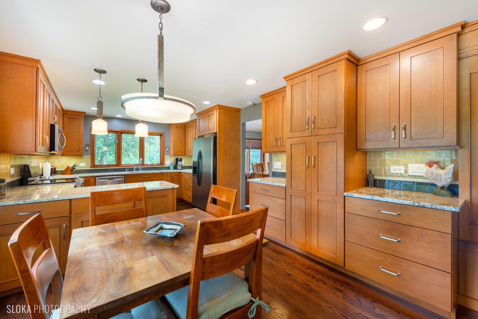 2920 Springbrook Road Crystal Lake, IL 60012 - Photo 6 of 39 a kitchen with stainless steel appliances kitchen island granite countertop a table chairs and a refrigerator