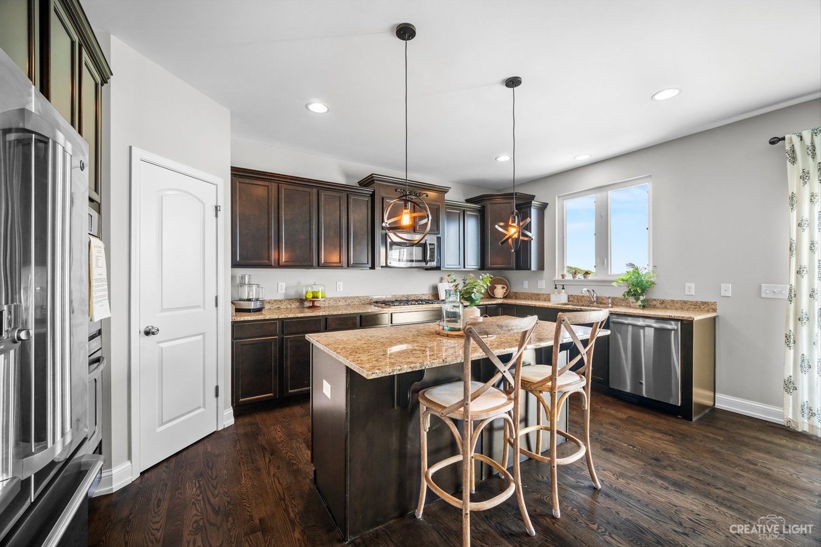 672 Ridgeview Lane Sugar Grove, IL 60554 - Photo 12 of 35 a kitchen with stainless steel appliances granite countertop a stove a refrigerator a kitchen island a sink cabinets and wooden floor
