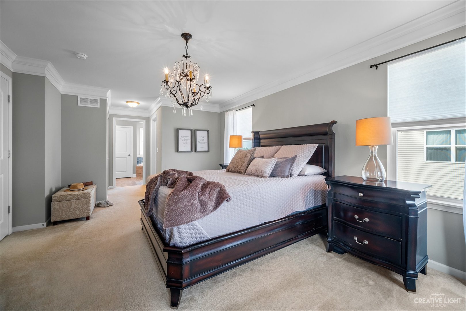672 Ridgeview Lane Sugar Grove, IL 60554 - Photo 20 of 35 a bedroom with a bed and a chandelier