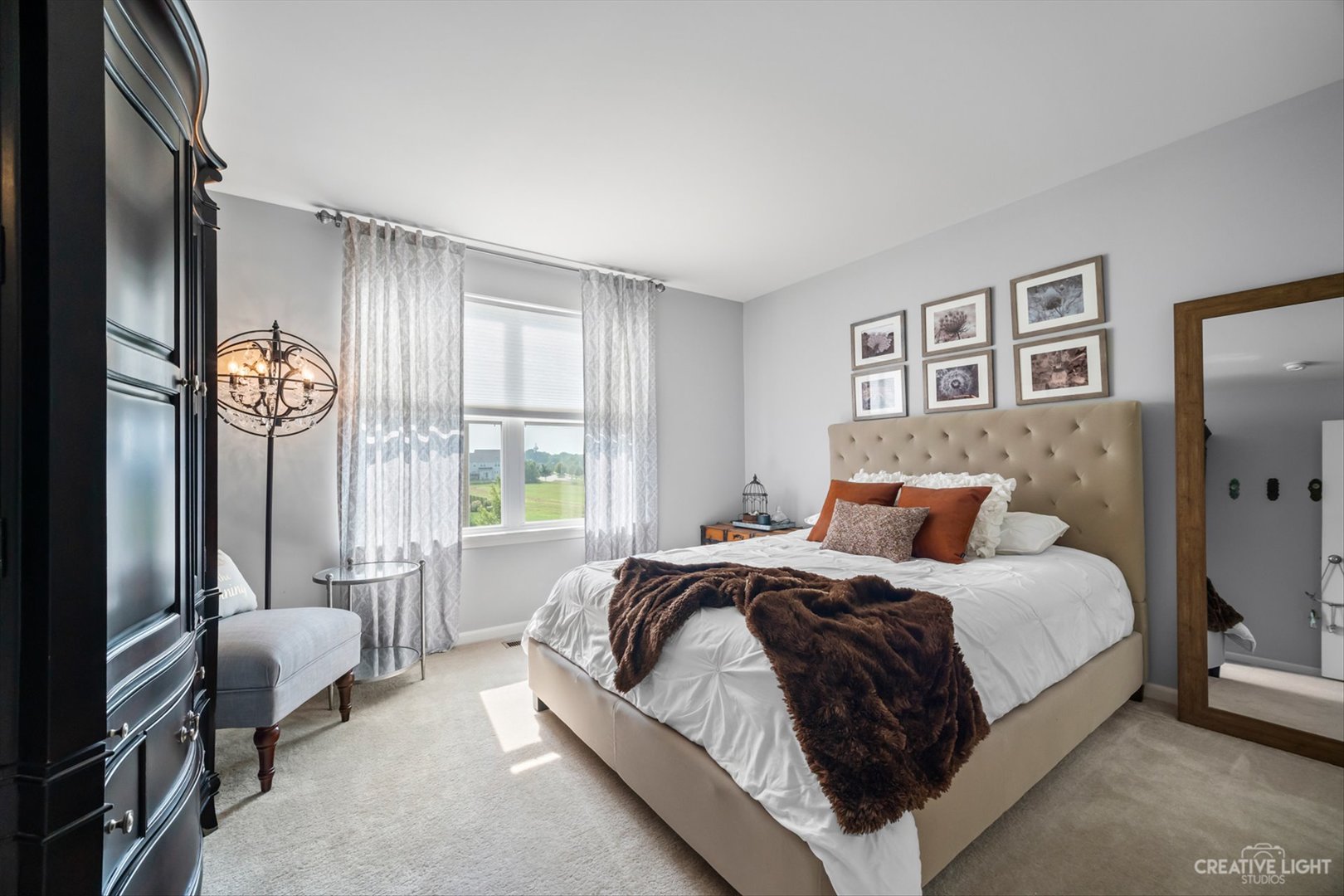672 Ridgeview Lane Sugar Grove, IL 60554 - Photo 27 of 35 a bedroom with a bed and a large mirror with a dresser