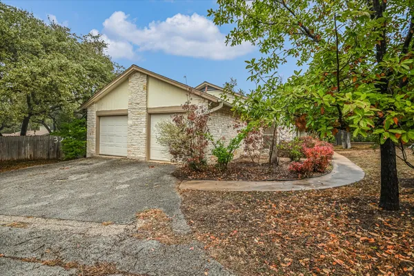 a view of a house with a tree in the yard