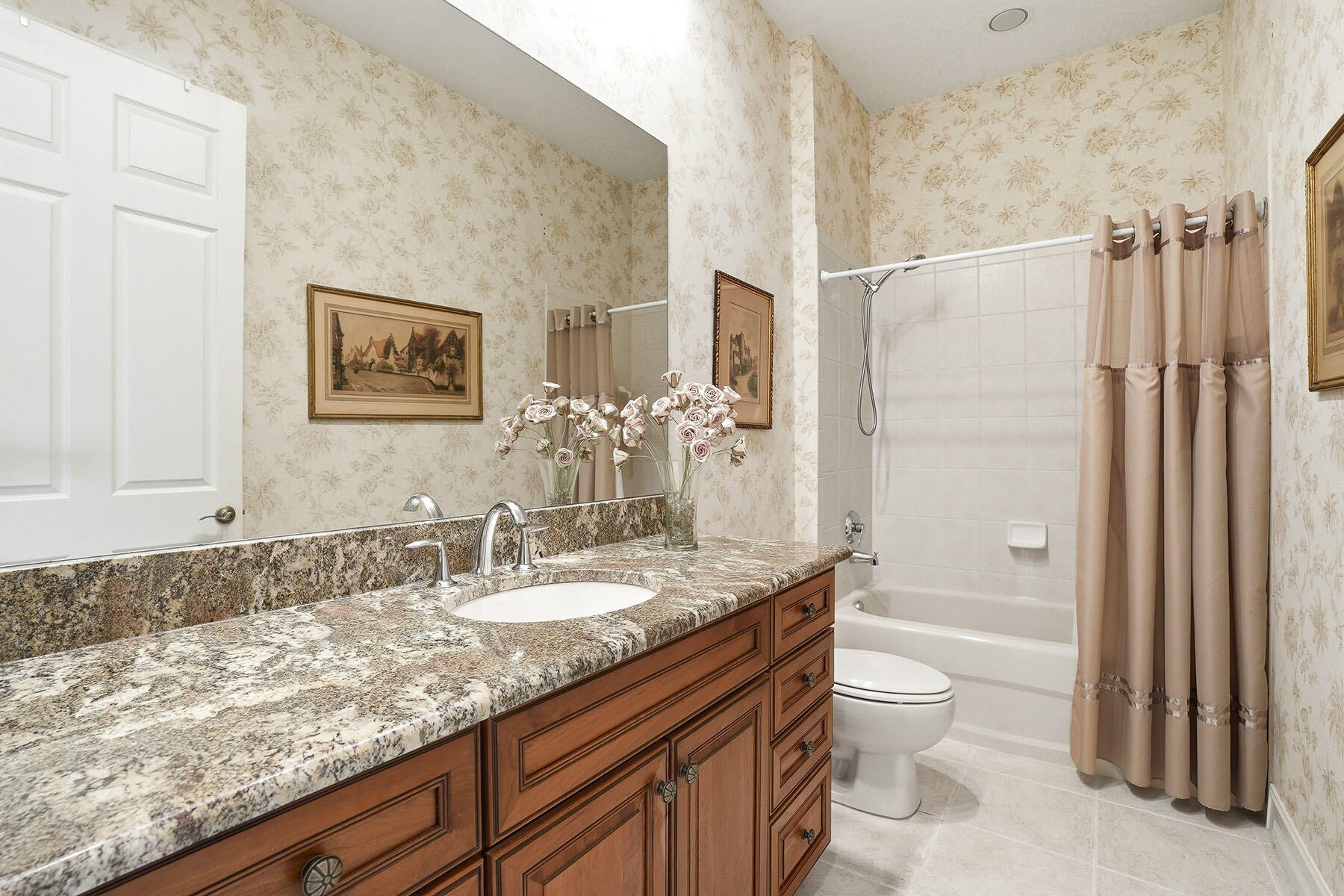 8605 Champions Point, Unit 103 Naples, FL 34113 - Photo 30 of 44 a bathroom with a granite countertop sink a toilet and shower
