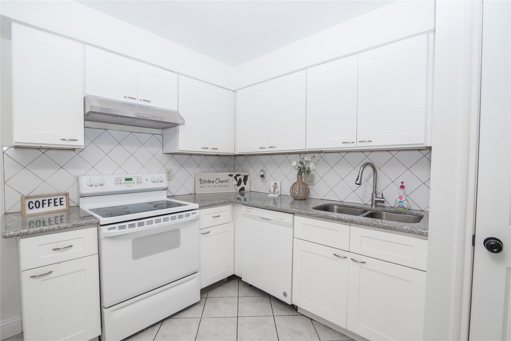 7237 Cook Road Houston, TX 77072 - Photo 11 of 21 a kitchen with white cabinets and white appliances
