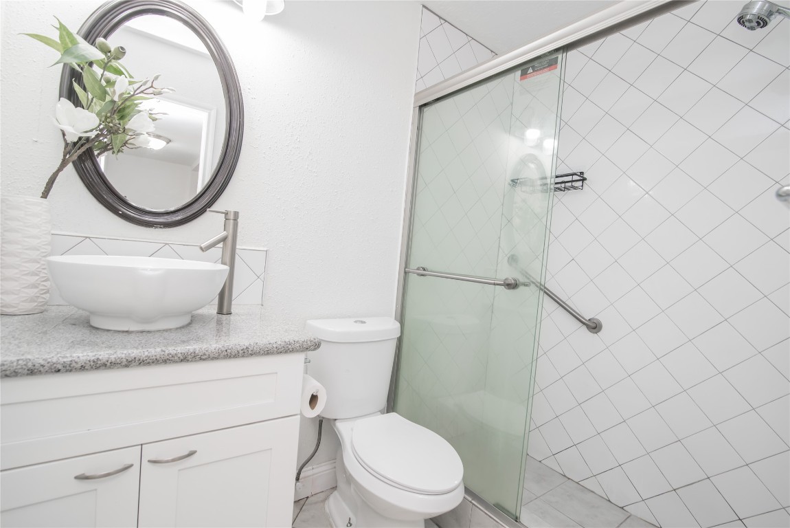 7237 Cook Road Houston, TX 77072 - Photo 16 of 21 Hall Bathroom w Granite Counter Top, White Modern Bowl Sink, & Standing Shower w Sliding Class Door
