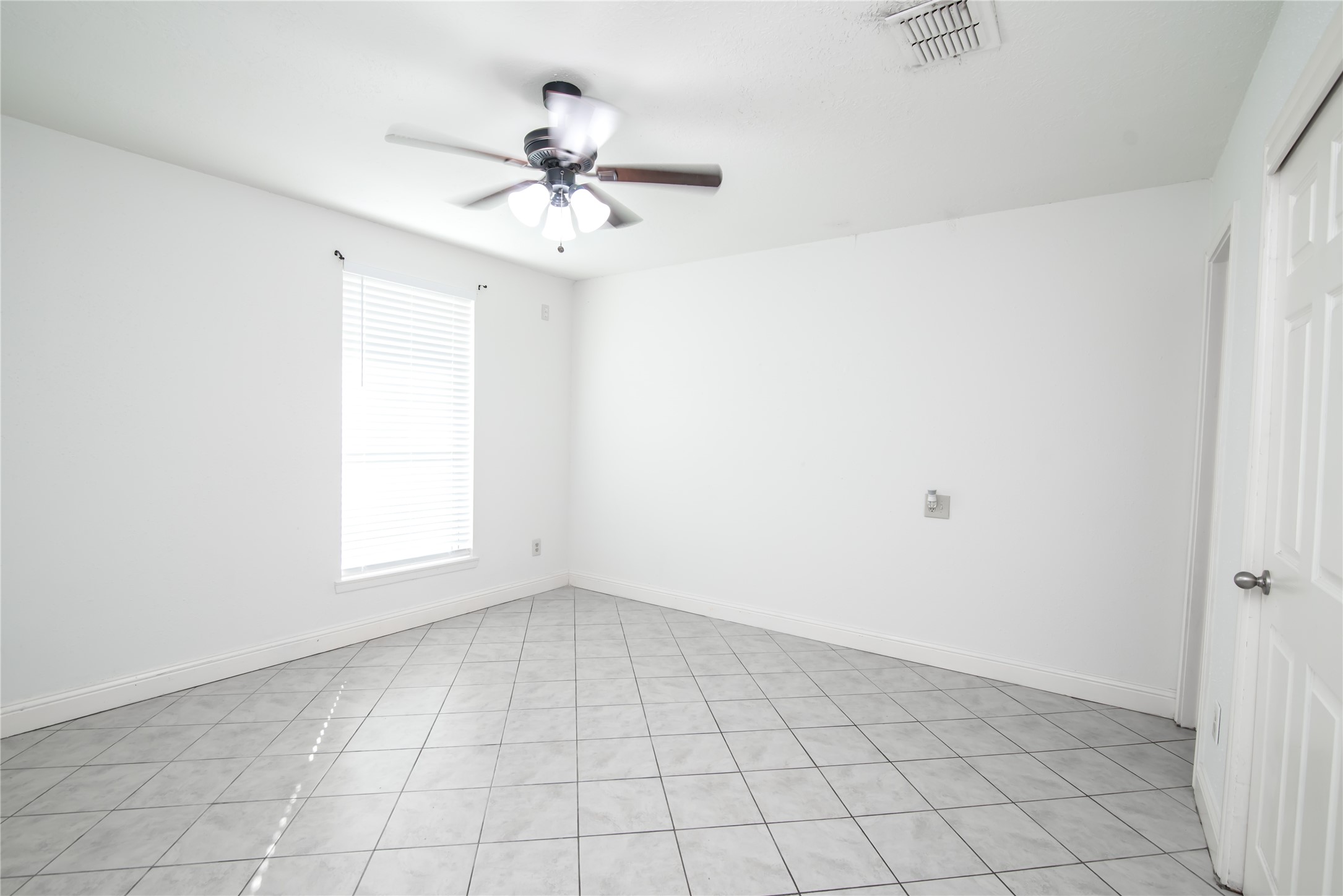 7237 Cook Road Houston, TX 77072 - Photo 17 of 21 a view of an empty room with a window