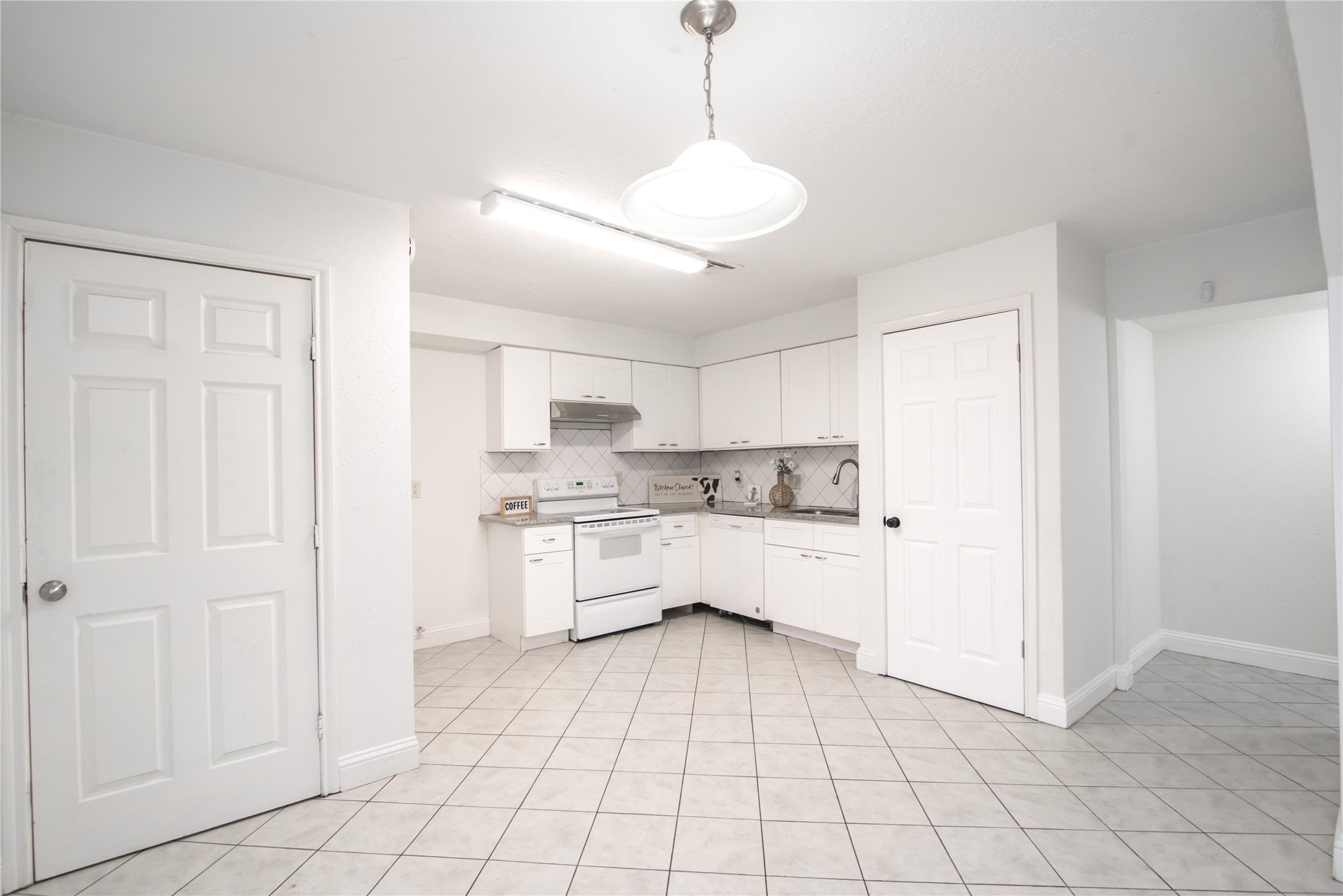 7237 Cook Road Houston, TX 77072 - Photo 10 of 21 a kitchen with white cabinets and white appliances