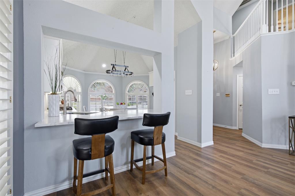 14584 Blueberry Court Addison, TX 75001 - Photo 13 of 40 a view of a dining room with furniture and wooden floor