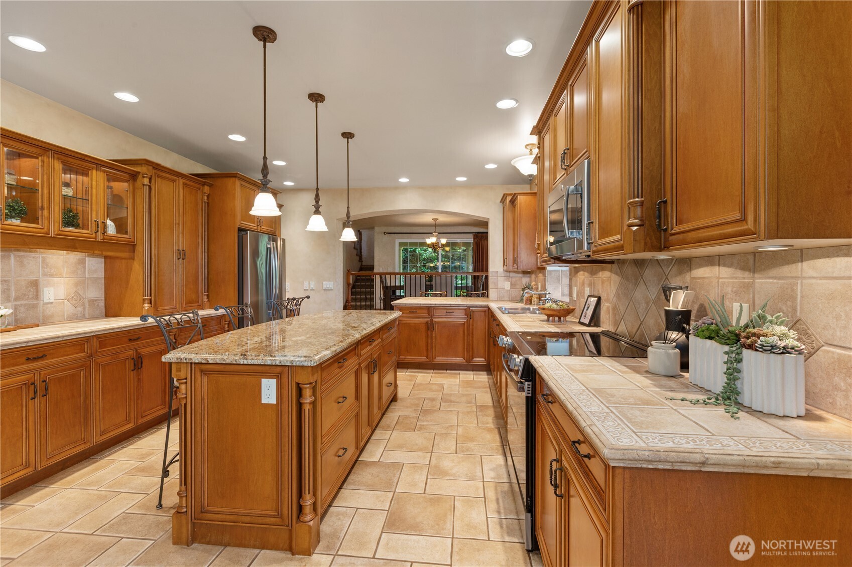 1788 Matz Road Ferndale, WA 98248 - Photo 16 of 40 a kitchen with stainless steel appliances granite countertop a sink a stove and a wooden floors