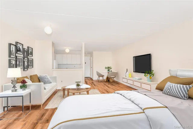 a hotel room with large couches and flat screen tv