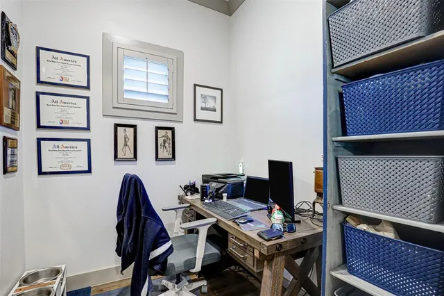 a view of a workspace with furniture and a window