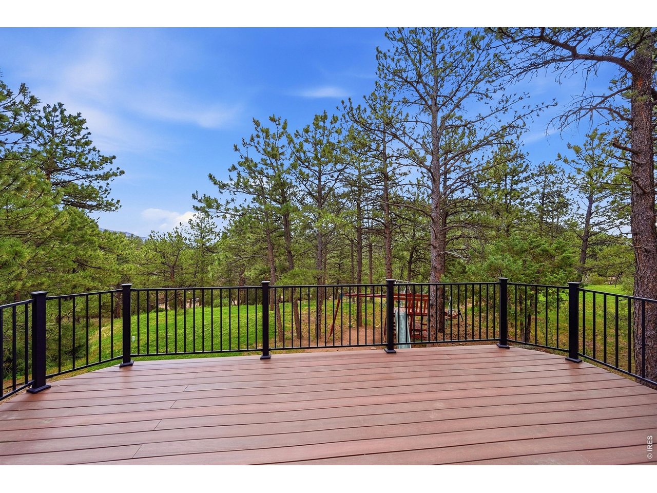 256 Choctaw Road Lyons, CO 80540 - Photo 43 of 50 a view of a balcony with wooden floor and fence