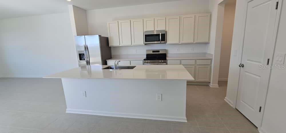 548 Hart Lane Dundee, FL 33838 - Photo 3 of 39 a kitchen with stainless steel appliances a refrigerator stove microwave and sink