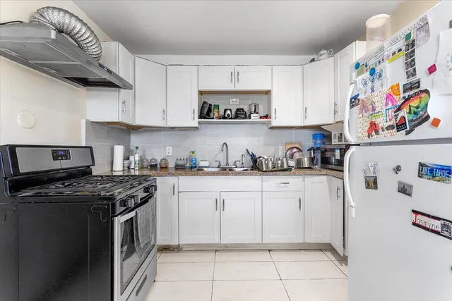 a kitchen with stainless steel appliances granite countertop a stove and a refrigerator