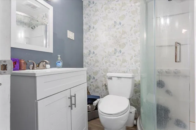 a bathroom with a sink toilet and shower