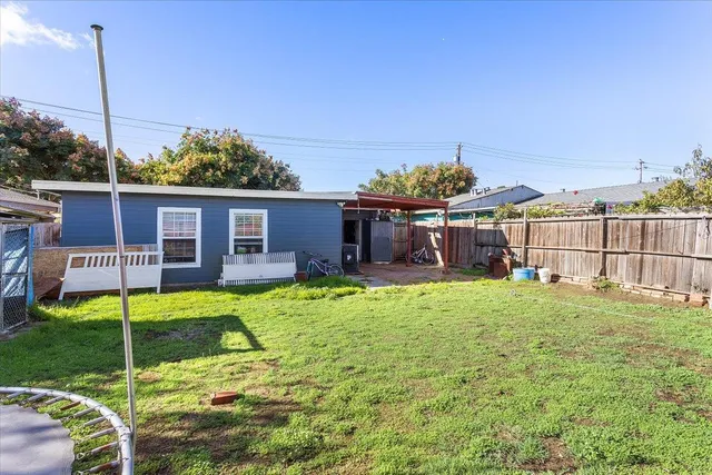 a view of a house with backyard porch and sitting area