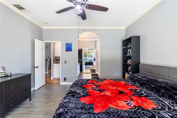 a bedroom with a bed and a chandelier