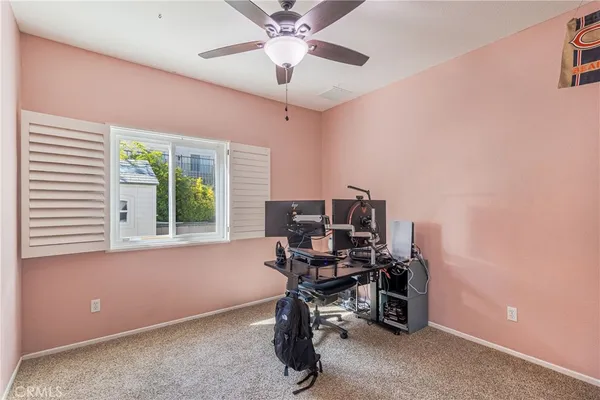 a view of a workspace with furniture and a window