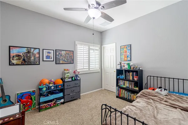 a bedroom with a bed and a book shelf