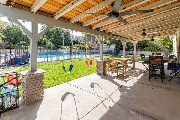 a view of a swimming pool with a lounge chairs in patio