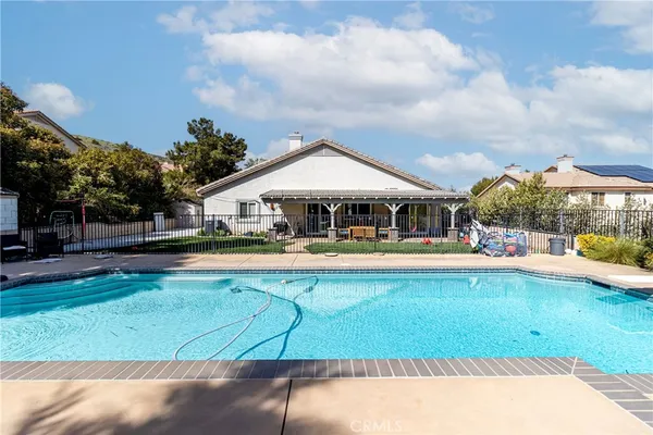 a front view of house with yard and swimming pool