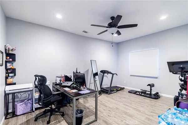 a view of a workspace with furniture and a window