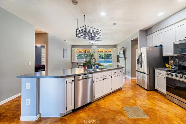 a kitchen with stainless steel appliances a refrigerator and a stove