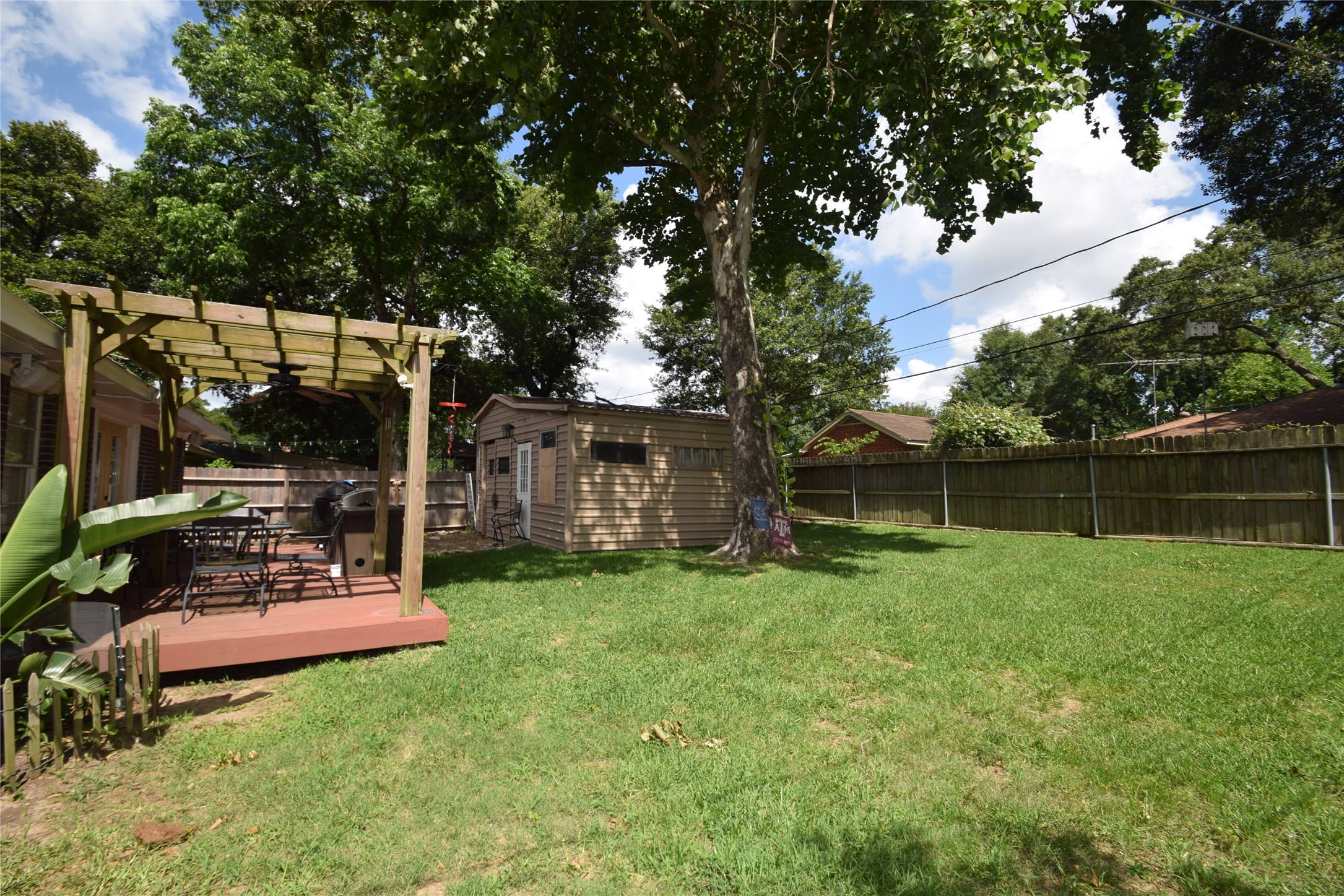 1130 Stonecrest Drive Houston, TX 77018 - Photo 25 of 28 Fully fenced backyard with storage building, decked patio area and summer kitchen area.