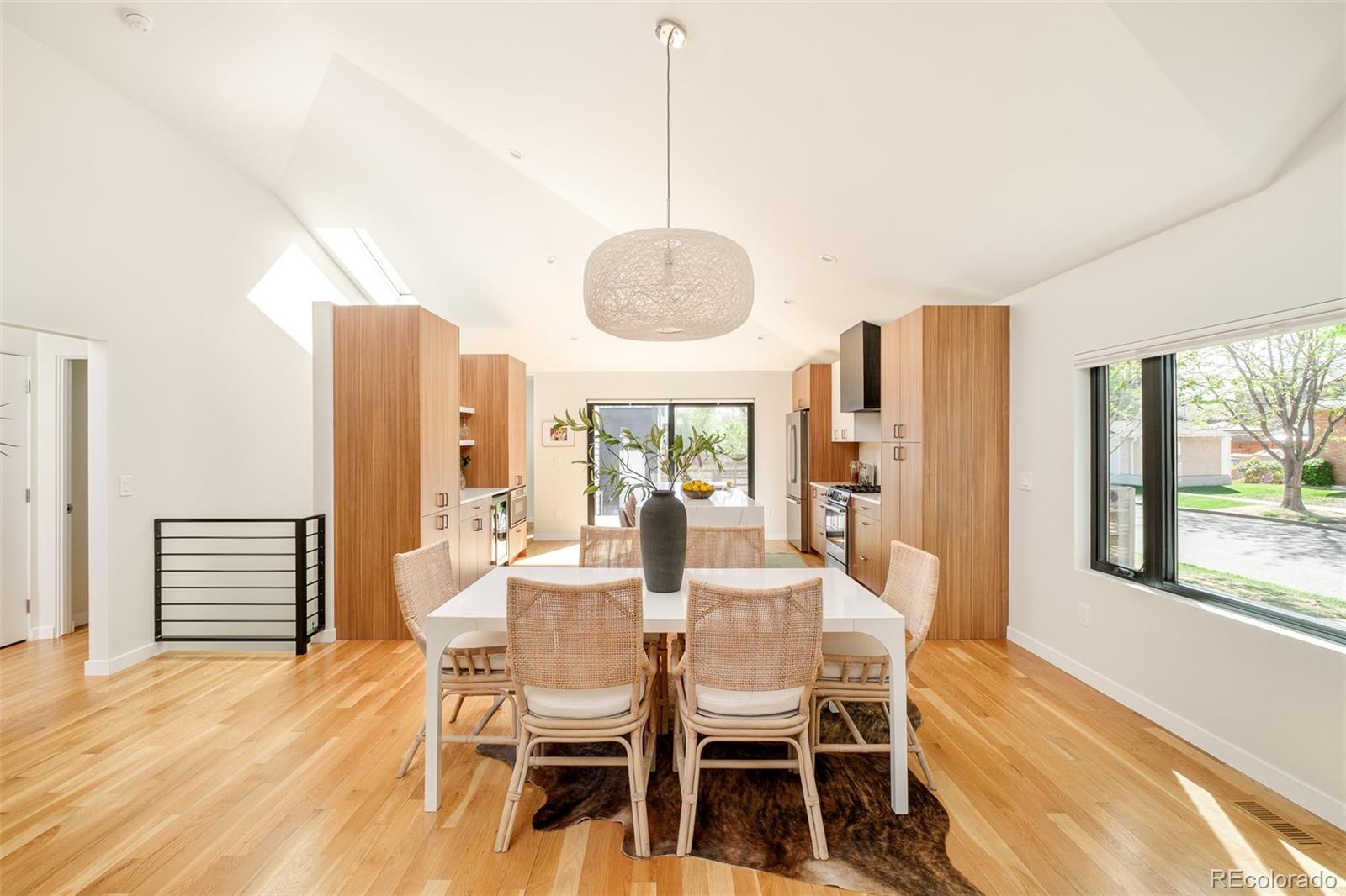 4100 Raleigh Street Denver, CO 80212 - Photo 14 of 48 a dining room with furniture a chandelier and wooden floor