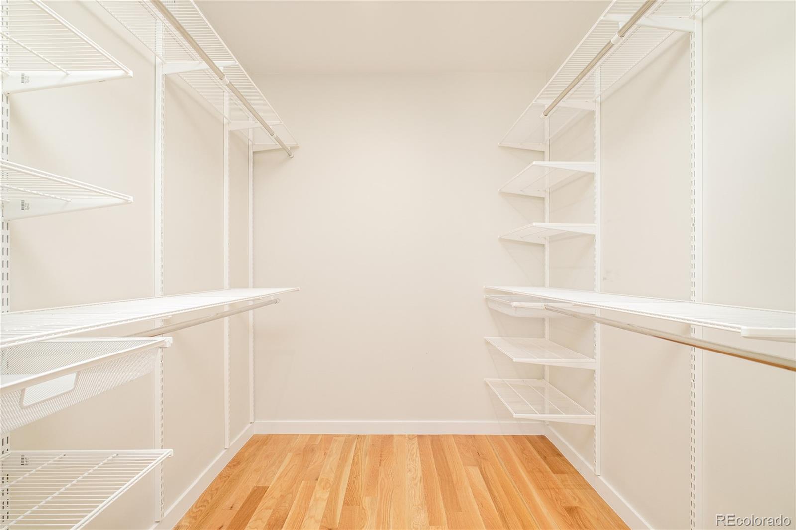 4100 Raleigh Street Denver, CO 80212 - Photo 22 of 48 a view of a bedroom with wooden floor and white walls