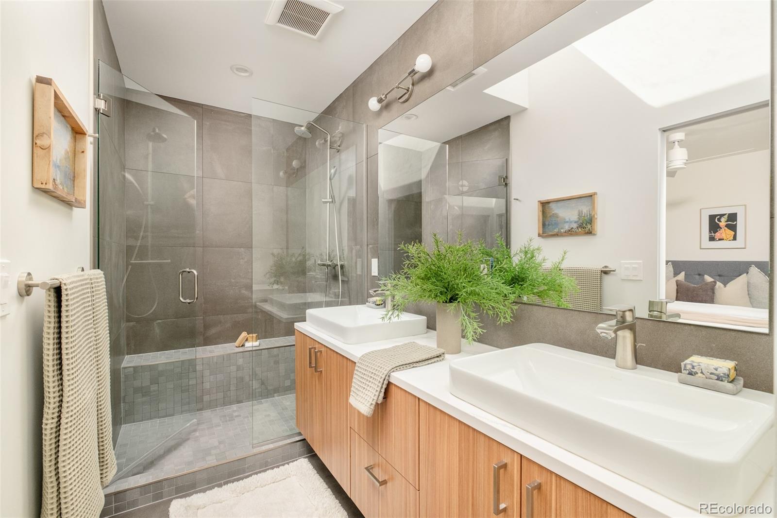 4100 Raleigh Street Denver, CO 80212 - Photo 24 of 48 a bathroom with a double vanity sink mirror and shower