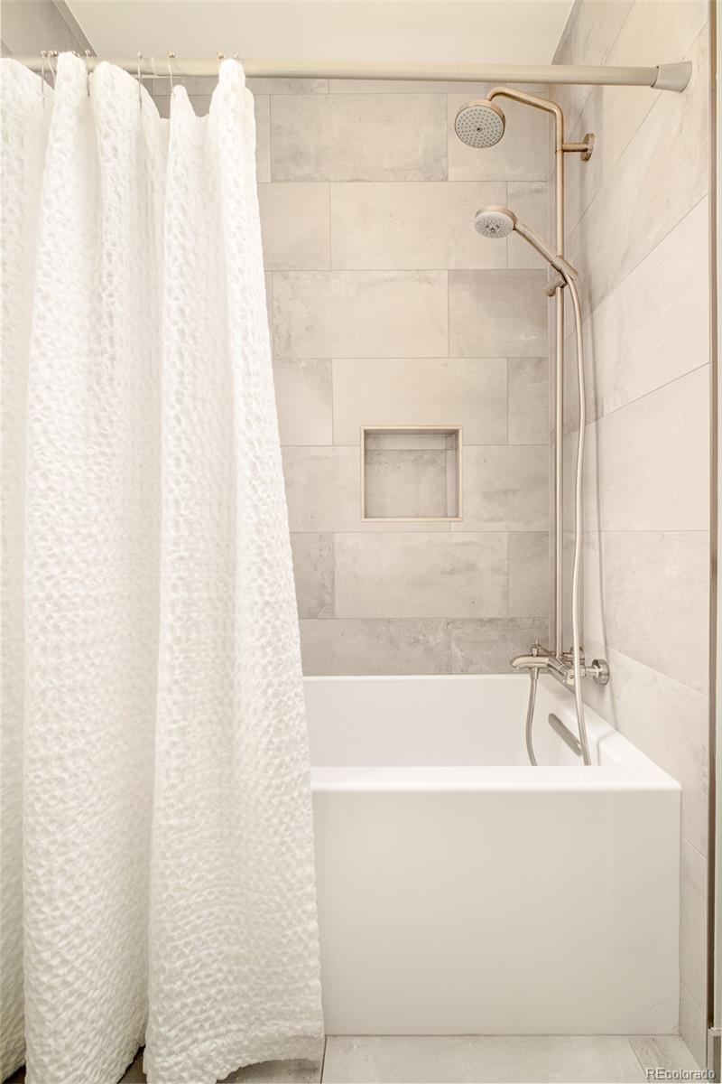4100 Raleigh Street Denver, CO 80212 - Photo 30 of 48 a bathroom with a shower and a bath tub