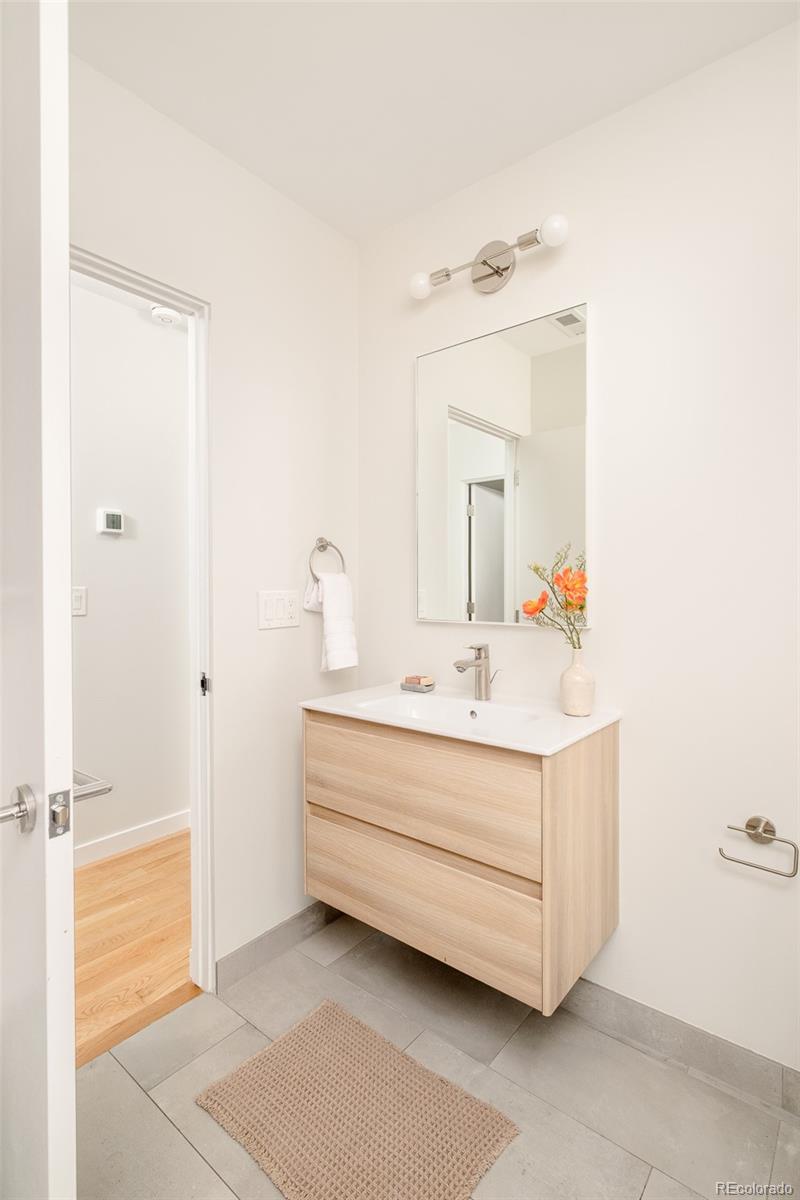 4100 Raleigh Street Denver, CO 80212 - Photo 31 of 48 a bathroom with a sink mirror and vanity