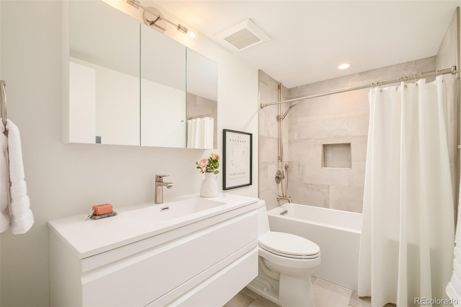 4100 Raleigh Street Denver, CO 80212 - Photo 37 of 48 a bathroom with a sink a toilet and shower