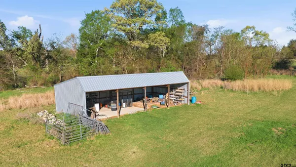 an aerial view of a residential houses with outdoor space