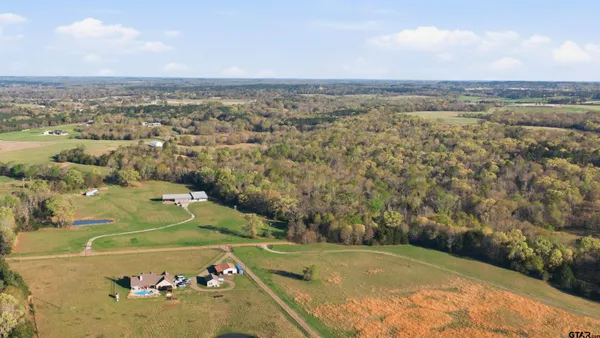 an aerial view of a residential houses and outdoor space
