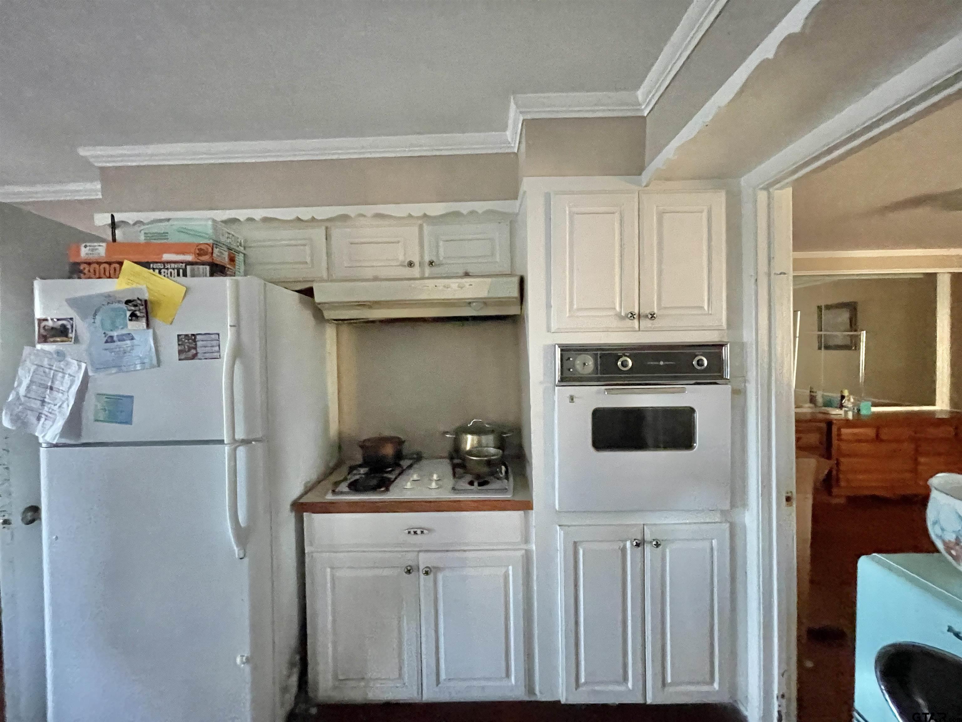 3300 Brookside Drive Tyler, TX 75701 - Photo 11 of 25 a kitchen with stainless steel appliances a refrigerator and cabinets