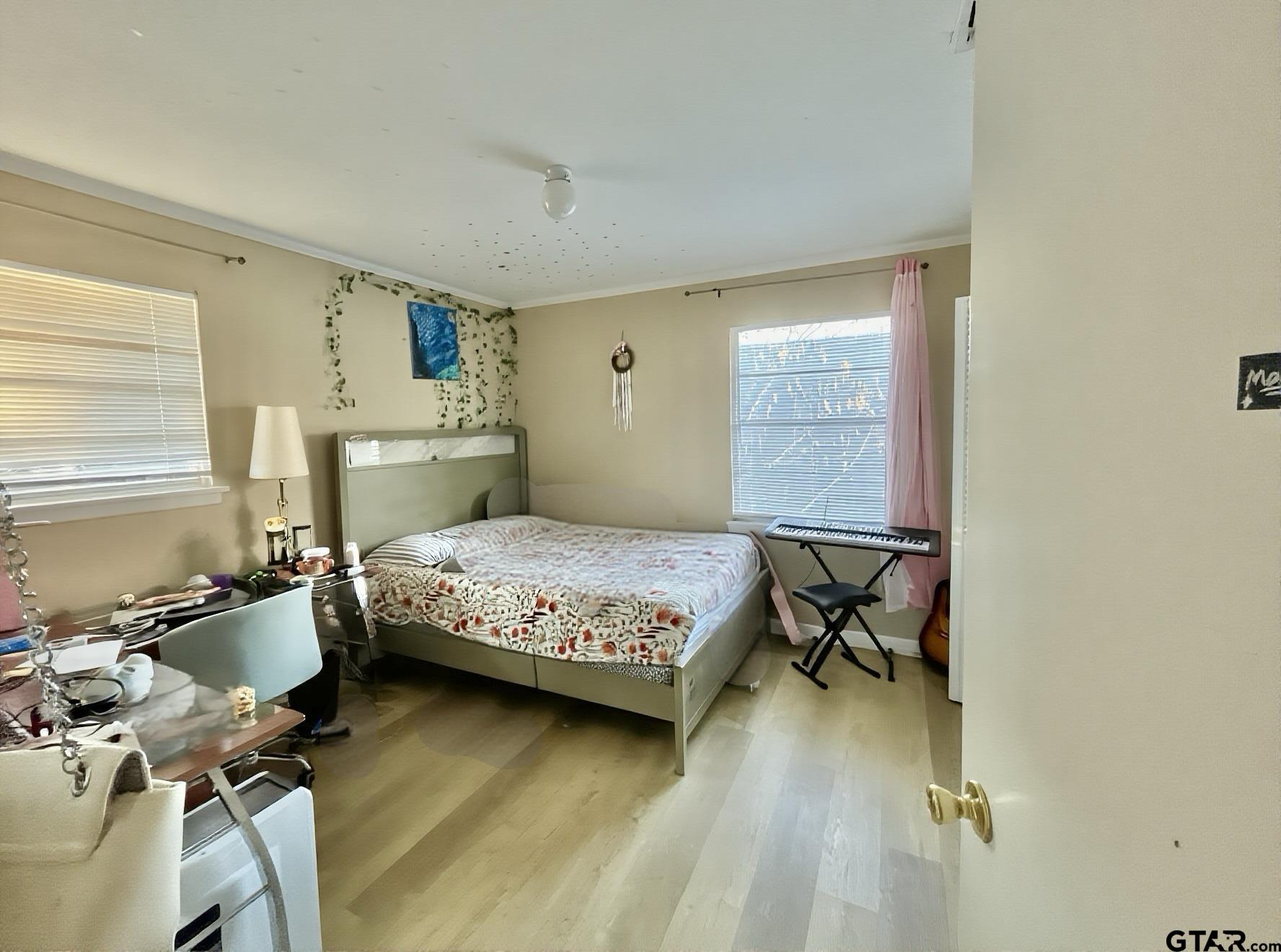 3300 Brookside Drive Tyler, TX 75701 - Photo 19 of 25 a bedroom with a bed and wooden floor