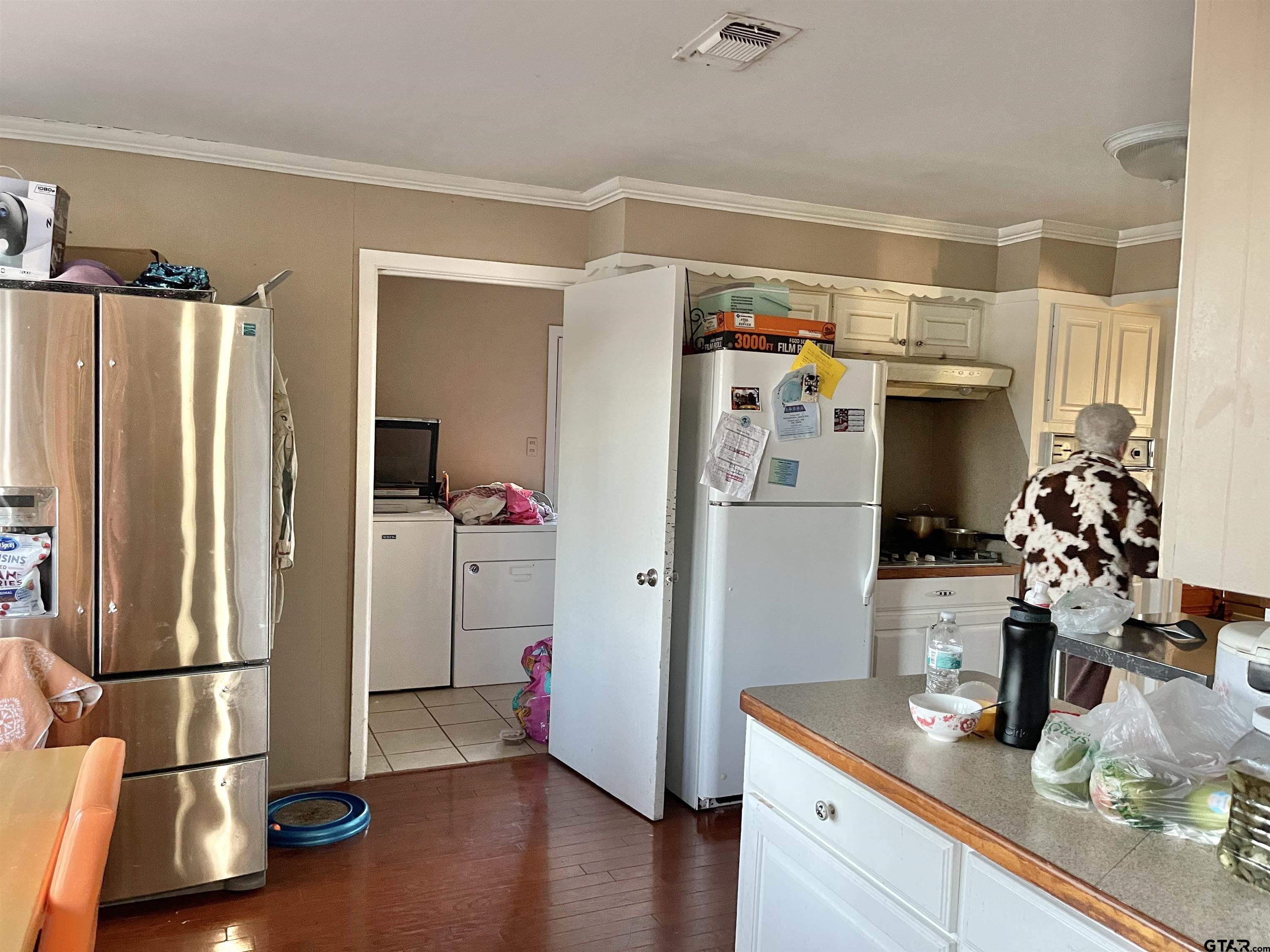 3300 Brookside Drive Tyler, TX 75701 - Photo 10 of 25 a kitchen with stainless steel appliances a refrigerator and wooden floor