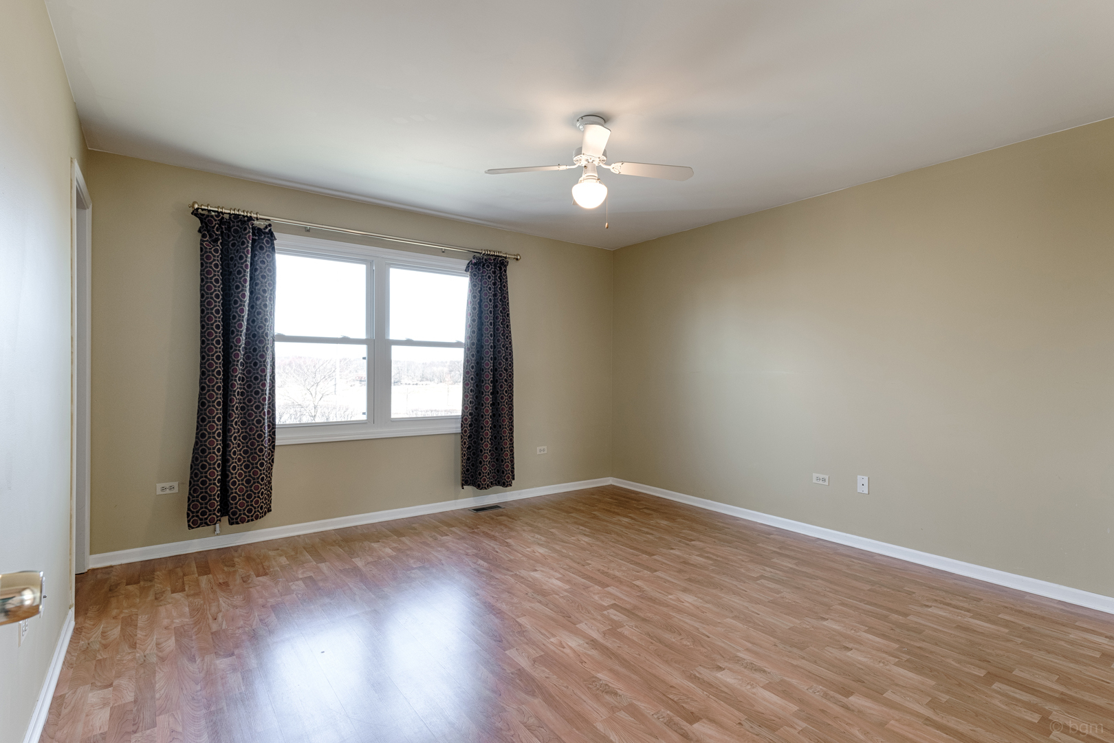 10 Ashcroft Court Bolingbrook, IL 60490 - Photo 13 of 30 a view of an empty room with wooden floor and a window