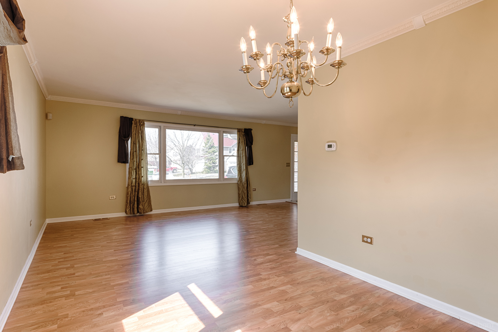 10 Ashcroft Court Bolingbrook, IL 60490 - Photo 6 of 30 a view of an empty room with wooden floor and a window