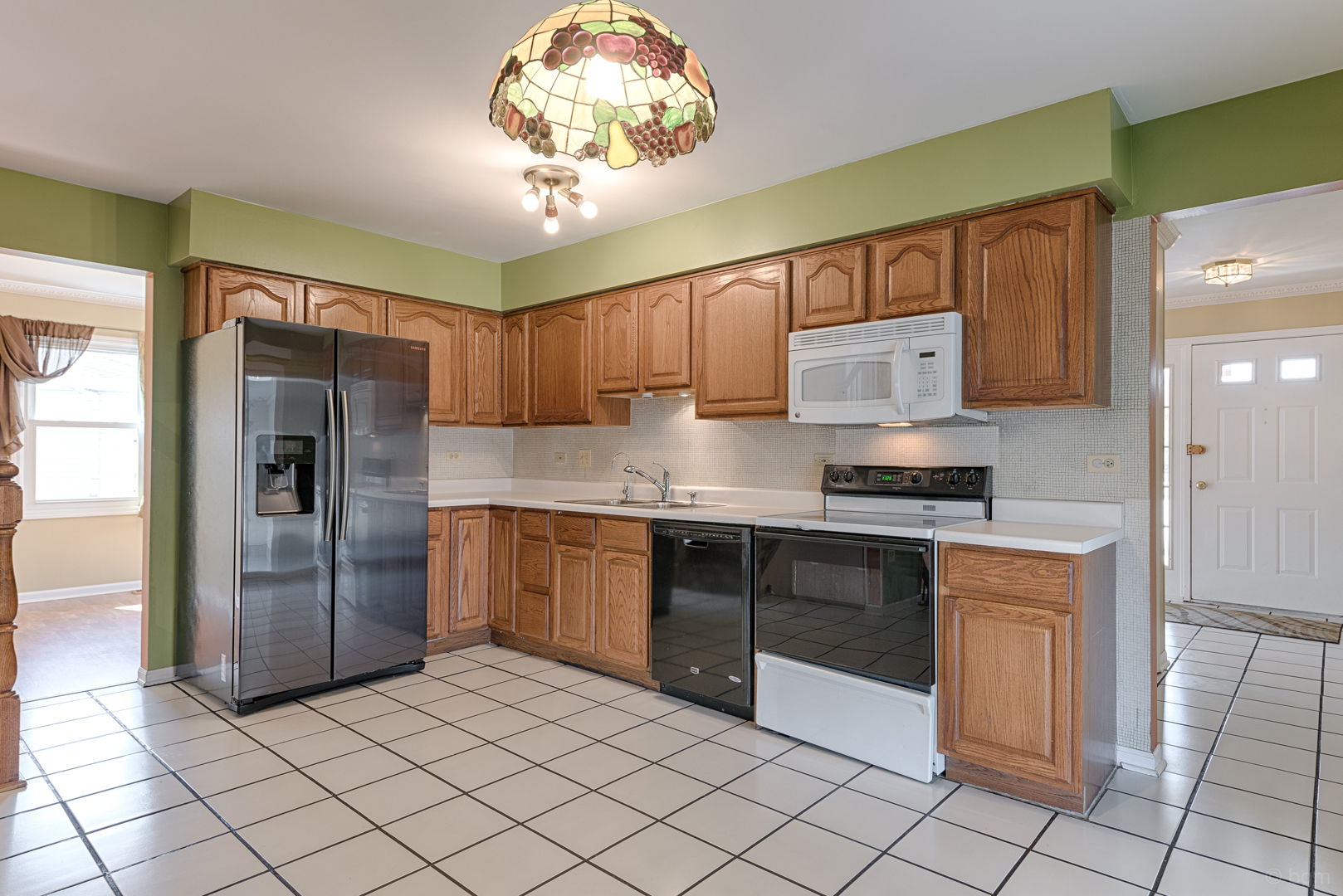 10 Ashcroft Court Bolingbrook, IL 60490 - Photo 9 of 30 a kitchen with stainless steel appliances granite countertop a refrigerator and a sink