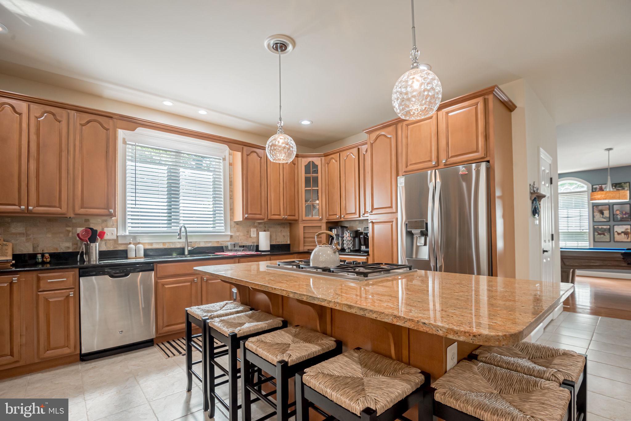 125 Cornwall Road Rehoboth Beach, DE 19971 - Photo 15 of 52 a kitchen with center island table and chairs