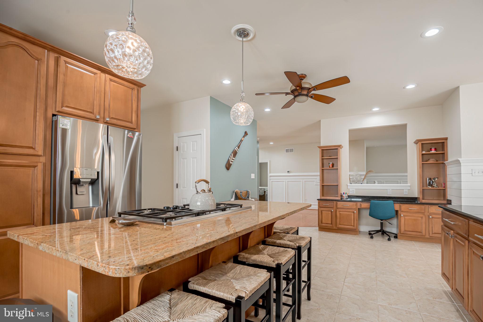125 Cornwall Road Rehoboth Beach, DE 19971 - Photo 16 of 52 a dining hall with stainless steel appliances kitchen island granite countertop furniture and a sink