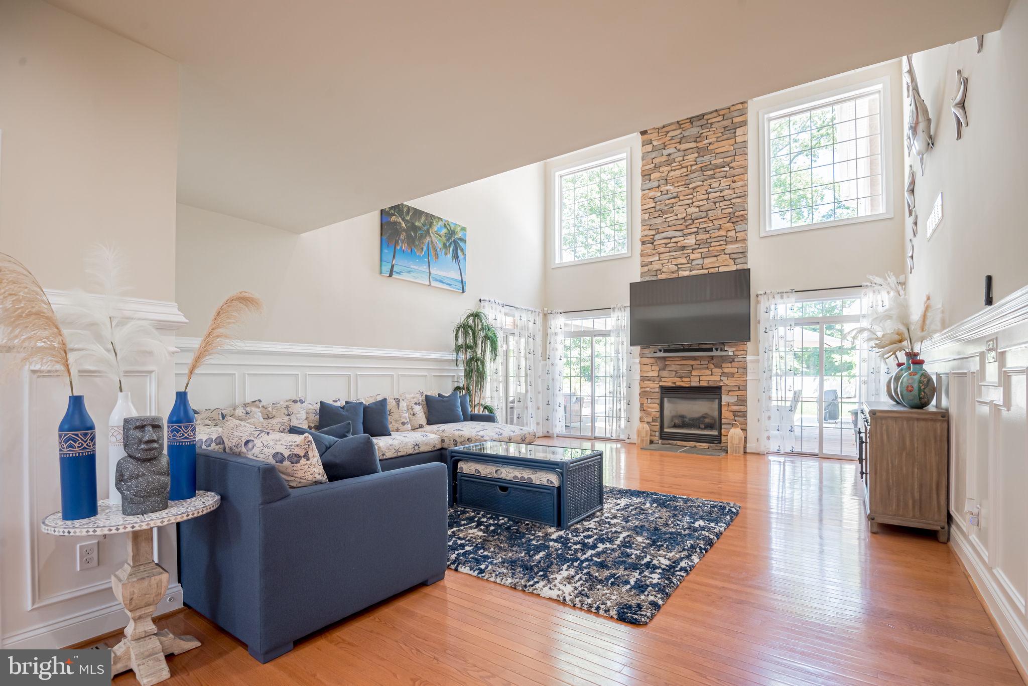 125 Cornwall Road Rehoboth Beach, DE 19971 - Photo 21 of 52 a living room with furniture a fireplace and a flat screen tv