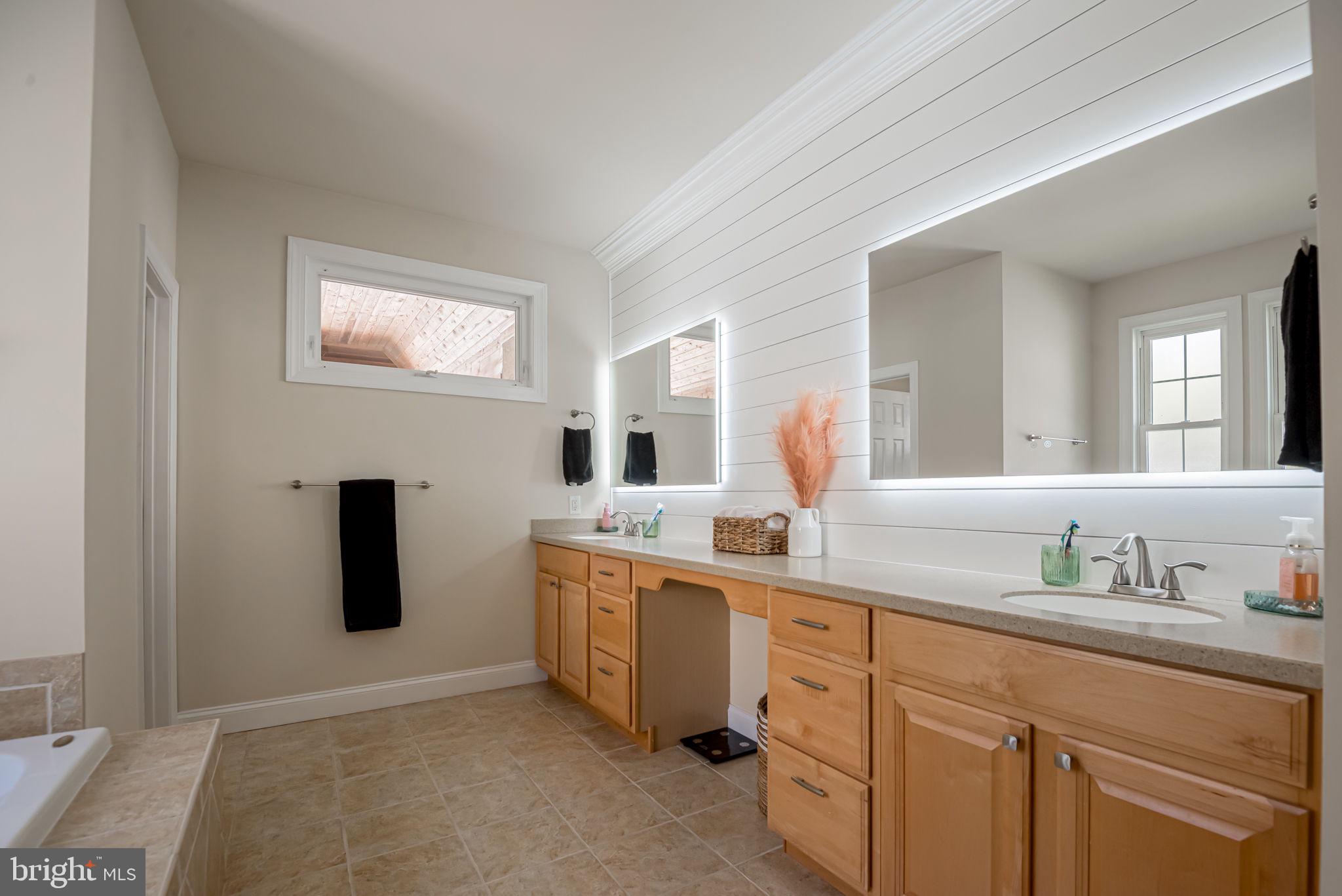 125 Cornwall Road Rehoboth Beach, DE 19971 - Photo 29 of 52 a spacious bathroom with a granite countertop sink and a mirror